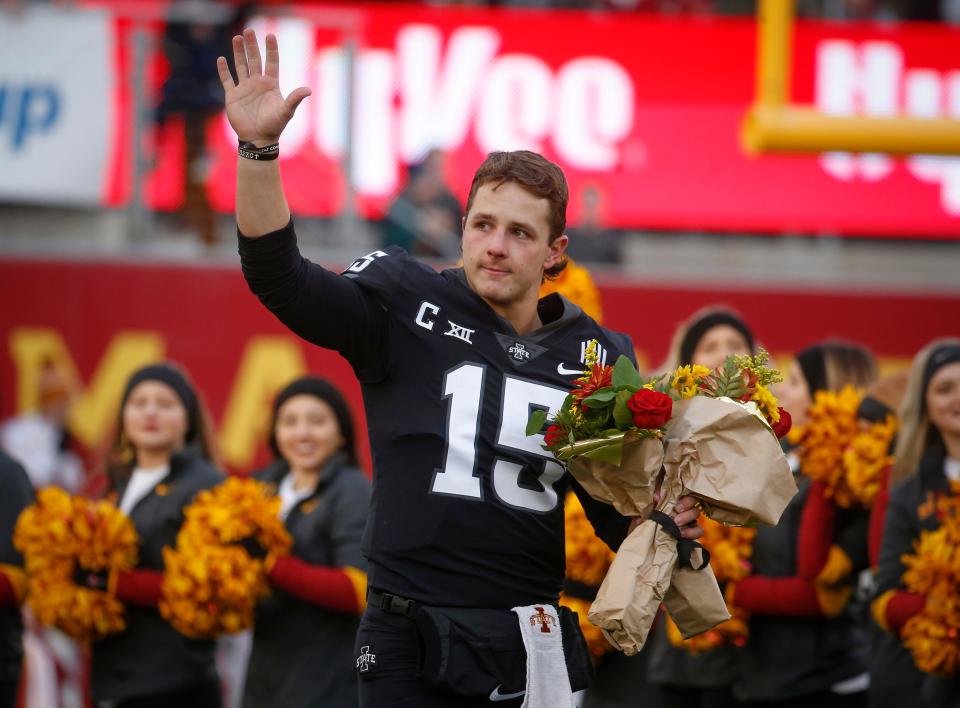 Iowa State senior quarterback Brock Purdy waves to fans as he carries flowers to his family during senior day introductions before Friday's kickoff against TCU at Jack Trice Stadium in Ames.