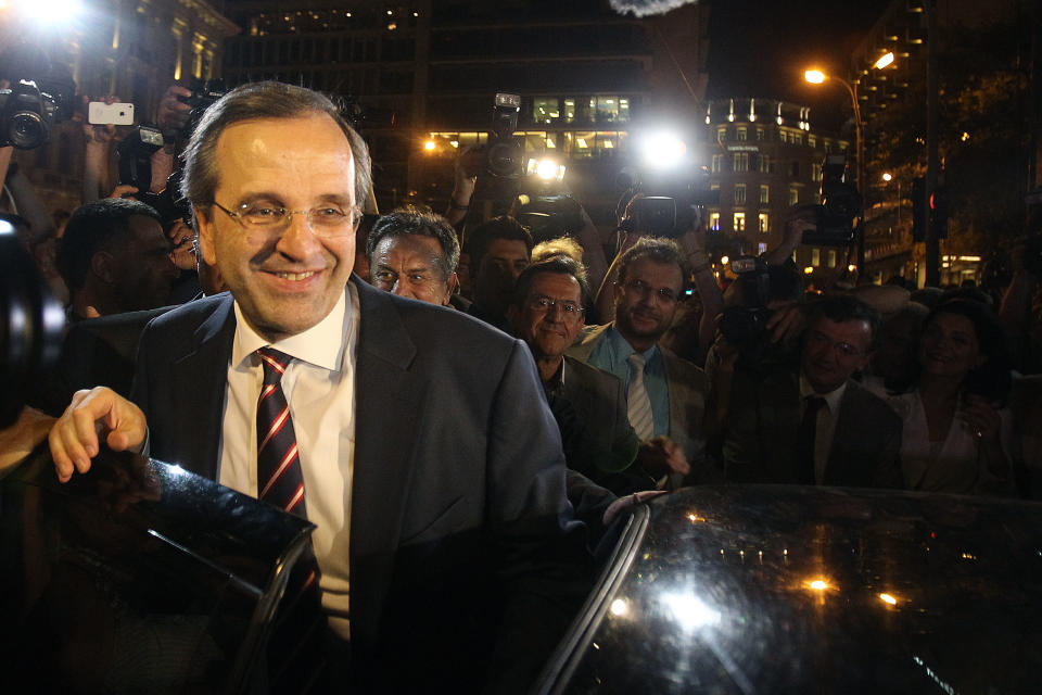 Leader of the New Democracy conservative party Antonis Samaras leaves an elections kiosk after speaking to his supporters at Syntagma square in Athens, Sunday, June 17, 2012. The pro-bailout New Democracy party came in first Sunday in Greece's national election, and its leader has proposed forming a pro-euro coalition government. (AP Photo/Petros Karadjias)