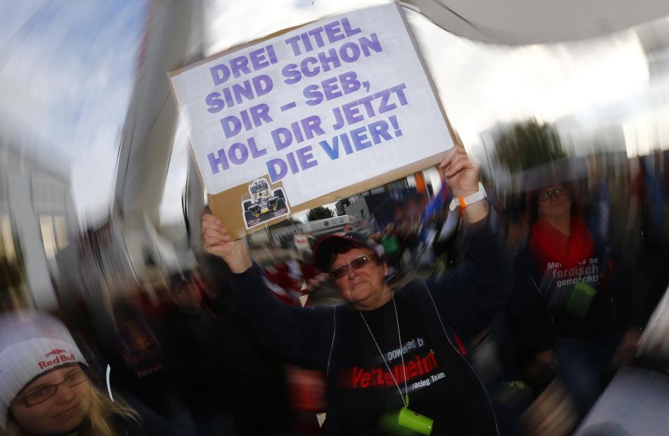 Supporter of Germany's Red Bull Formula One driver Sebastian Vettel holds a placard during public viewing of the Formula One Grand Prix of India in Heppenheim