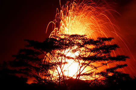 Lava erupts on the outskirts of Pahoa during ongoing eruptions of the Kilauea Volcano in Hawaii, U.S., May 18, 2018. REUTERS/Terray Sylvester