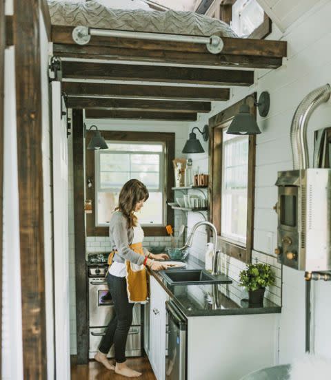 <p>Although (very) small, this cooking space features a a 24-inch under-counter fridge, a 20-inch four-burner gas range, and ample granite counter space.</p>