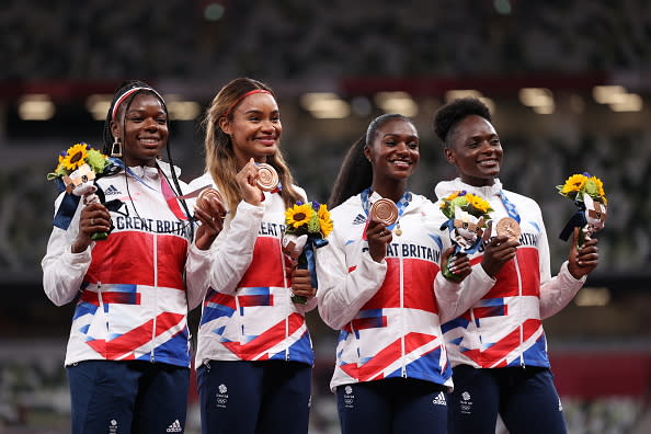 TOKYO, JAPAN - AUGUST 07: Bronze medal winners Asha Philip, Imani Lansiquot, Dina Asher-Smith and Daryll Neita of Team Great Britain stand on the podium during the medal ceremony for the Women’s 4 x 100 Relay on on day fifteen of the Tokyo 2020 Olympic Games at Olympic Stadium on August 07, 2021 in Tokyo, Japan. (Photo by Christian Petersen/Getty Images)