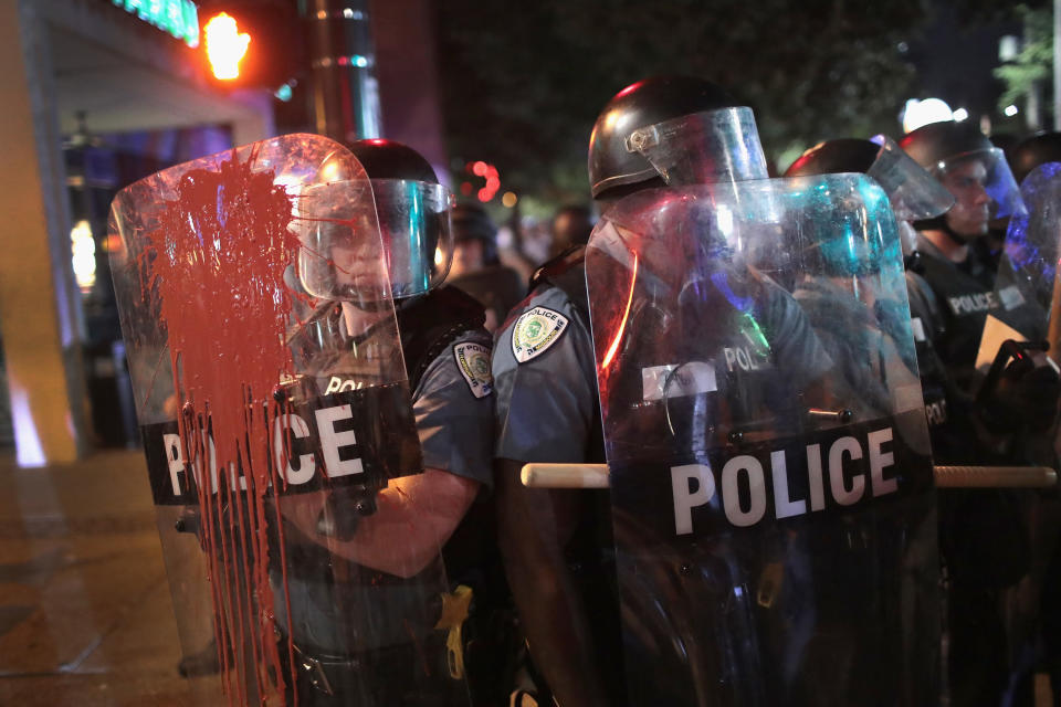 <p>Paint thrown by a protestor runs down the shield of a Police officer during a demonstration to protest the acquittal of former St. Louis police officer Jason Stockley on Sept. 16, 2017 in St. Louis, Mo. (Photo: Scott Olson/Getty Images) </p>