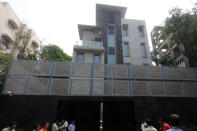 Media stand outside the new home of Indian cricketer Sachin Tendulkar new in Mumbai on September 28, 2011. Tendulkar fulfilled his dream of living in a house of his own as he moved into a sprawling bungalow at Perry Cross Road in suburban Bandra area. AFP PHOTO