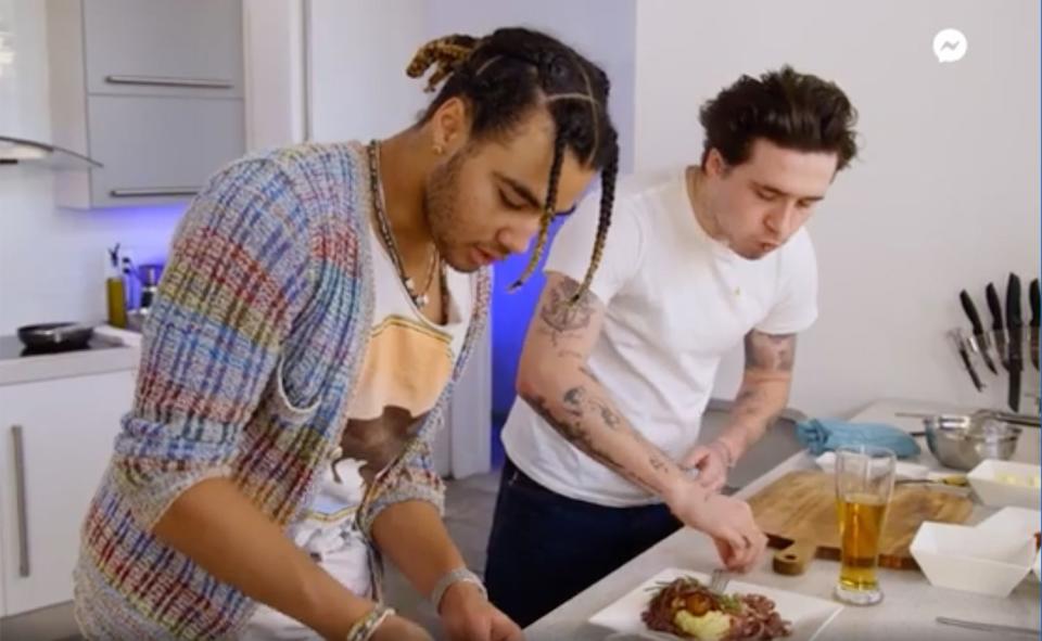 <p>In the newest episode of his Facebook show <em>Cookin' with Brooklyn</em>, the <a href="https://people.com/tag/brooklyn-beckham/" rel="nofollow noopener" target="_blank" data-ylk="slk:model and photographer;elm:context_link;itc:0;sec:content-canvas" class="link ">model and photographer</a> showed rapper <a href="https://www.instagram.com/24kgoldn/" rel="nofollow noopener" target="_blank" data-ylk="slk:24kGoldn;elm:context_link;itc:0;sec:content-canvas" class="link ">24kGoldn</a> how to make a British staple: <a href="https://www.instagram.com/tv/CYWyK6yJJ5U/?utm_source=ig_web_copy_link" rel="nofollow noopener" target="_blank" data-ylk="slk:bangers and mash;elm:context_link;itc:0;sec:content-canvas" class="link ">bangers and mash</a> (a.k.a. sausage and mashed potatoes). The pair made a vegan version of the dish with veggie sausage, mashed potatoes and onion gravy.</p>