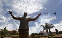 South African military and police helicopters fly past a 9-metre (30-feet) bronze statue of the late former President Nelson Mandela after it was unveiled as part of the Day of Reconciliation Celebrations at the Union Buildings in Pretoria December 16, 2013. REUTERS/Thomas Mukoya