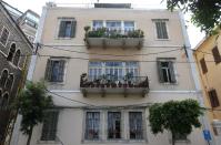 In this April 8, 2014 photo, an old traditional building is threatened with demolition to make way for a controversial highway through a historic quarter, in Beirut, Lebanon. Lebanon's booming real estate sector has led to the destruction of hundreds of traditional Lebanese houses known for their stoned, arched headways, elaborate balconies and colorful windows and gardens. (AP Photo/Hussein Malla)