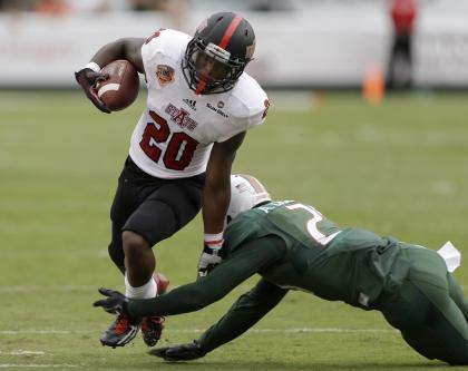 Arkansas State wide receiver Brandon Cox (20) is tackled by Miami defensive back Antonio Crawford (21) during the first half of an NCAA college football game in Miami Gardens, Fla., Saturday, Sept. 13, 2014. (AP Photo/Alan Diaz)