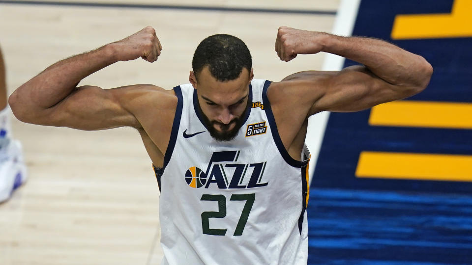 Utah Jazz center Rudy Gobert flexes his muscles after scoring against Los Angeles Clippers Nicolas Batum during the second half of an NBA basketball game Friday, Jan. 1, 2021, in Salt Lake City. (AP Photo/Rick Bowmer)