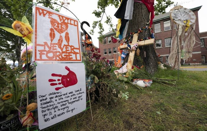 Signs are pictured at a memorial outside the former Kamloops Indian Residential School in British Columbia.