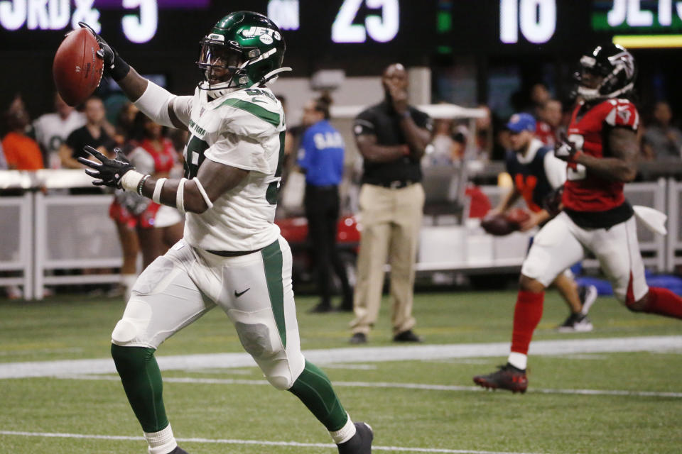 New York Jets outside linebacker James Burgess (58) runs the ball into the end zone for a touchdown against the Atlanta Falcons during the second half an NFL preseason football game, Thursday, Aug. 15, 2019, in Atlanta. (AP Photo/Andrea Smith)