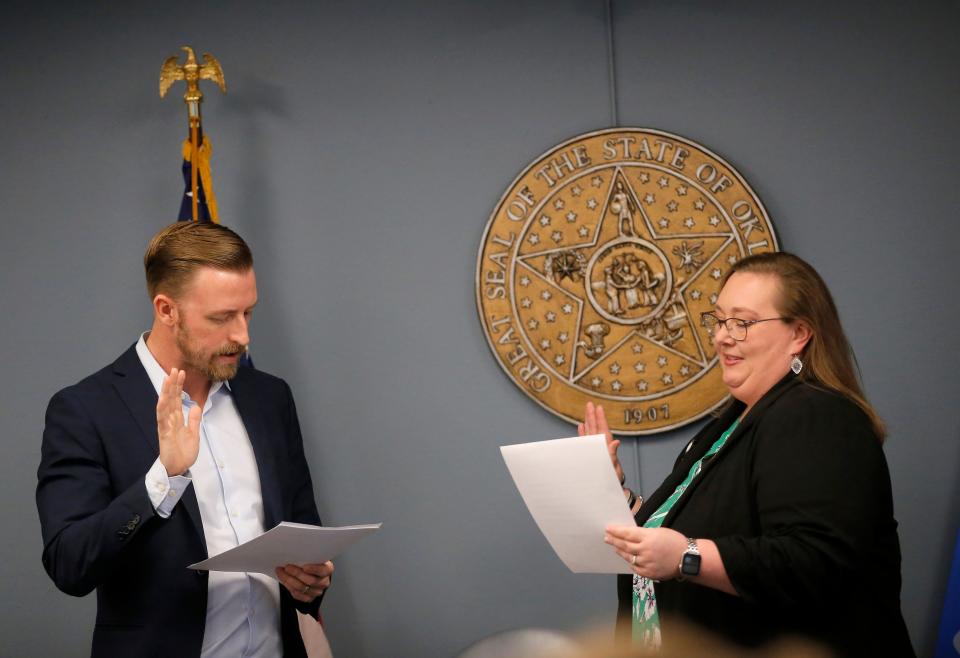 Ryan Walters, state schools superintendent, swears in Katie Quebedeaux during a March meeting of the Oklahoma State Board of Education.