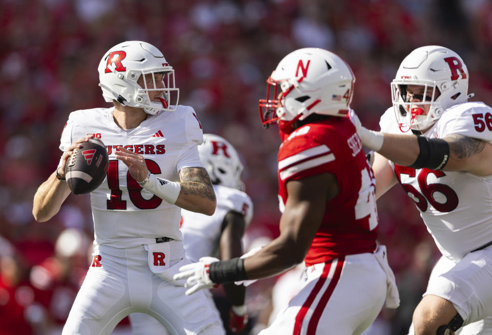 Rutgers quarterback Athan Kaliakmanis, left, sets up a pass against Nebraska during the first half of an NCAA college football game Saturday, Oct. 5, 2024, in Lincoln, Neb. (AP Photo/Rebecca S. Gratz)