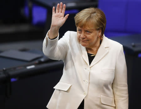 Chancellor Angela Merkel waves during a session of the German lower house of parliament Bundestag to elect a new chancellor, in Berlin, Germany, March 14, 2018. REUTERS/Kai Pfaffenbach