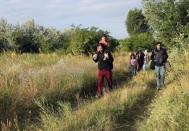 Migrants from Afghanistan walk just after they crossed the border from Serbia to Hungary, near the village of Asotthalom, Hungary, on June 29, 2015. REUTERS/Laszlo Balogh