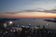 In this photo provided by the Prime Minister's Office, Greek Prime Minister Kyriakos Mitsotakis announces the opening of the tourist season during a news conference, on the Greek island of Santorini, Saturday, June 13, 2020. (Dimitris Papamitsos/Greek Prime Minister's Office via AP)