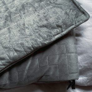 Still Life Of Gray Weighted Blanket In Bedroom