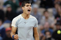 Spain's Carlos Alcaraz clenches his fist after scoring a point against Spain's Albert Ramos-Vinolas during their second round match at the French Open tennis tournament in Roland Garros stadium in Paris, France, Wednesday, May 25, 2022. (AP Photo/Jean-Francois Badias)