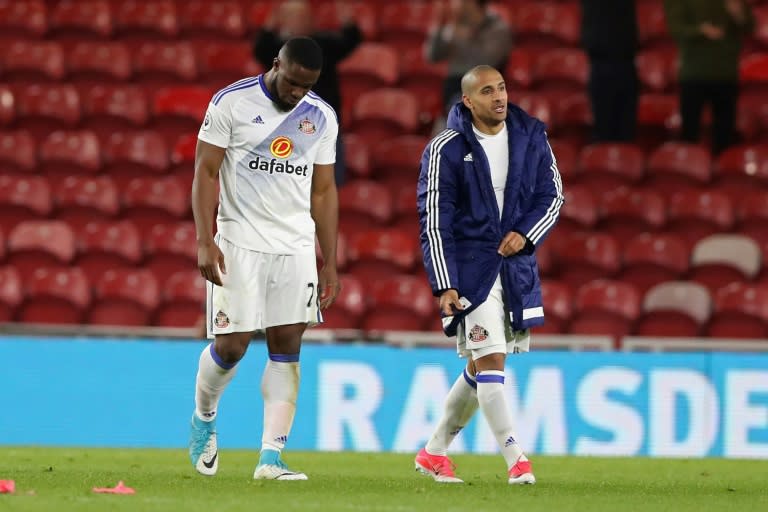 Sunderland's striker Victor Anichebe (L) and Sunderland's midfielder Wahbi Khazri walk from the picth after the English Premier League football match against Middlesbrough April 26, 2017