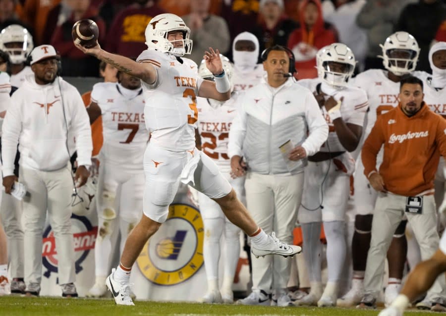 Texas quarterback Quinn Ewers (3) passes the ball on the fly during the first half of an NCAA college football game against Iowa State, Saturday, Nov. 18, 2023, in Ames, Iowa. (AP Photo/Matthew Putney)