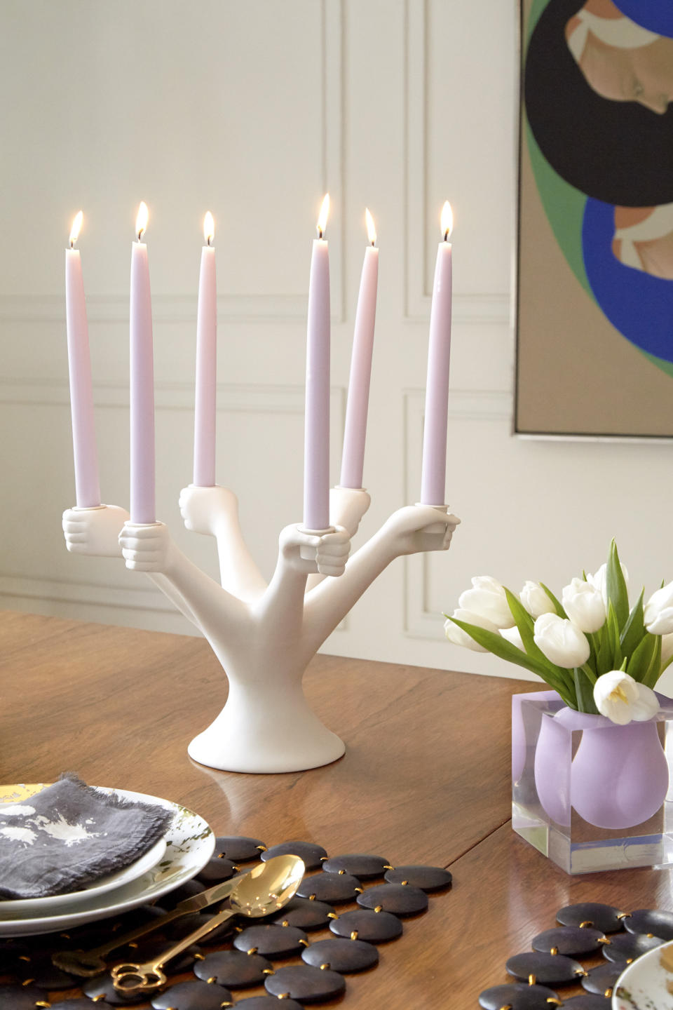 This image provided by Jonathan Adler shows a candlestick holder. Designer Jonathan Adler pays homage to Paris' Pompidou Center with a candelabra he calls Eve; a ringlet of white porcelain hands stands ready to grip tapers, like a circle of dancers. (Jonathan Adler via AP)