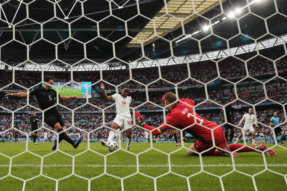 England's Raheem Sterling, center, scores the opening goal during the Euro 2020 Soccer Championship round of 16 match between England and Germany at Wembley Stadium in London, Tuesday, June 29, 2021. (AP Photo/Frank Augstein)