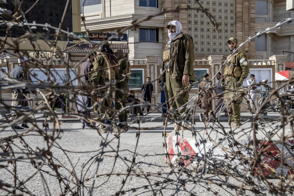 Taliban fighters stand guard at the explosion site, near the Foreign Ministry in Kabul, Afghanistan, Monday, March 27, 2023. A suicide bomber has struck near the foreign ministry in the Afghan capital, killing at least six people and wounding about a dozen. (AP Photo/Ebrahim Noroozi)