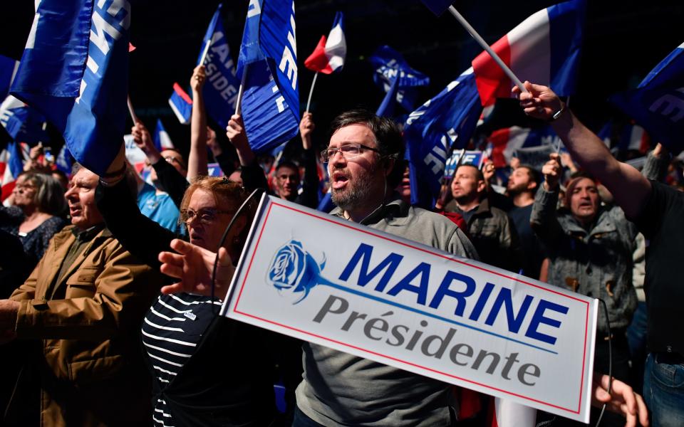 Far-Right supporters of Front National leader Marine Le Pen wave flags and banners at a campaign rally. Britain is watching the election closely - 2017 Getty Images