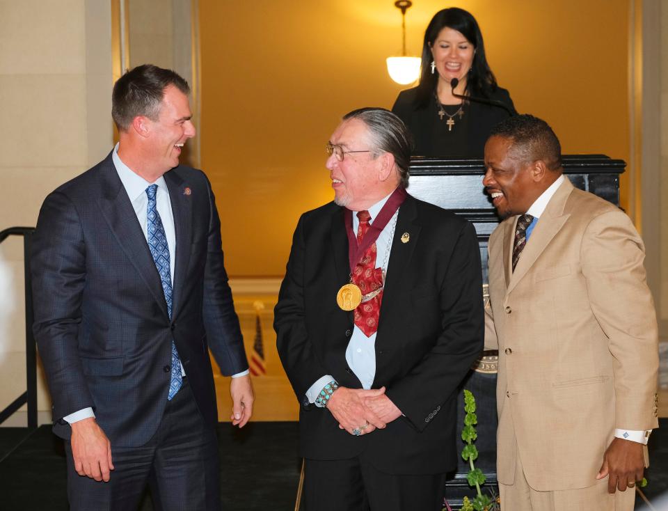 Harvey Pratt receives a Special Recognition Award in 2021 at the Governor's Arts Awards for Excellence in the Arts at the Capitol. Presenting him with the award are Gov. Kevin Stitt, left, and Oklahoma Arts Council Chair Charles Moore.