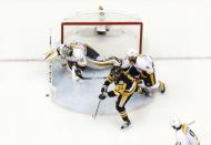 May 29, 2017; Pittsburgh, PA, USA; Nashville Predators goalie Pekka Rinne (35) makes a save against Pittsburgh Penguins left wing Chris Kunitz (14) as Predators defenseman Ryan Ellis (4) defends during the first period in game one of the 2017 Stanley Cup Final at PPG PAINTS Arena. Mandatory Credit: Charles LeClaire-USA TODAY Sports