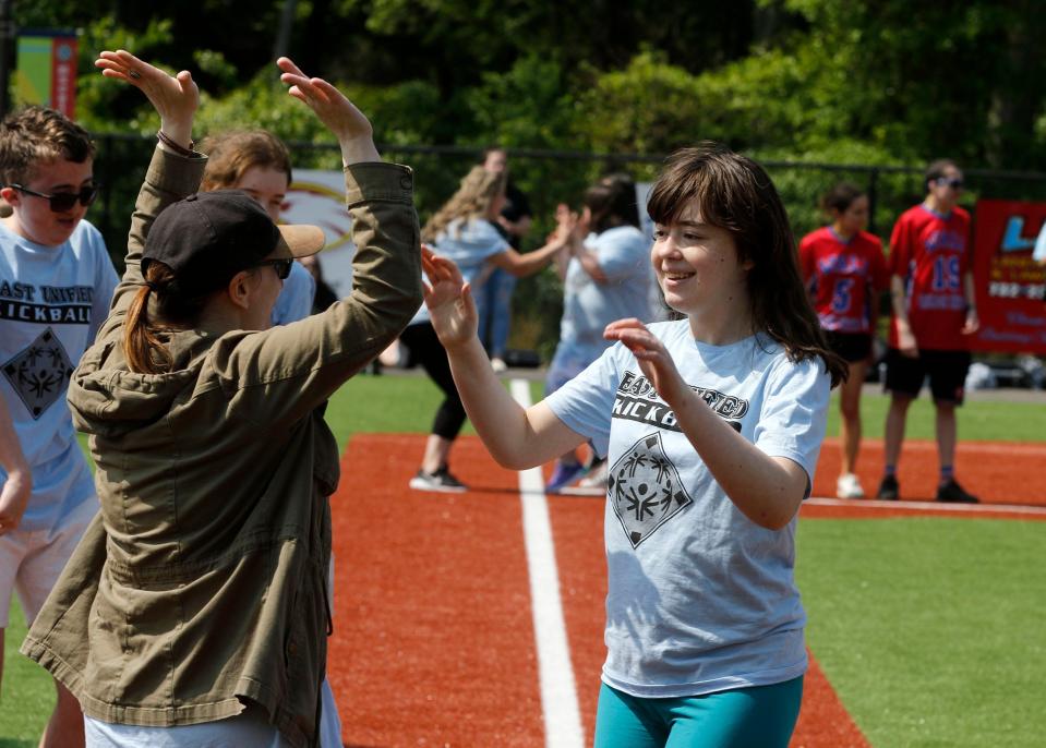 Toms River East Unified's Theresa Salvatore gets congratulated at home plate after rounding the bases during kick ball game against Wall Unified at the Toms River Field of Dreams Tuesday, May 16, 2023.