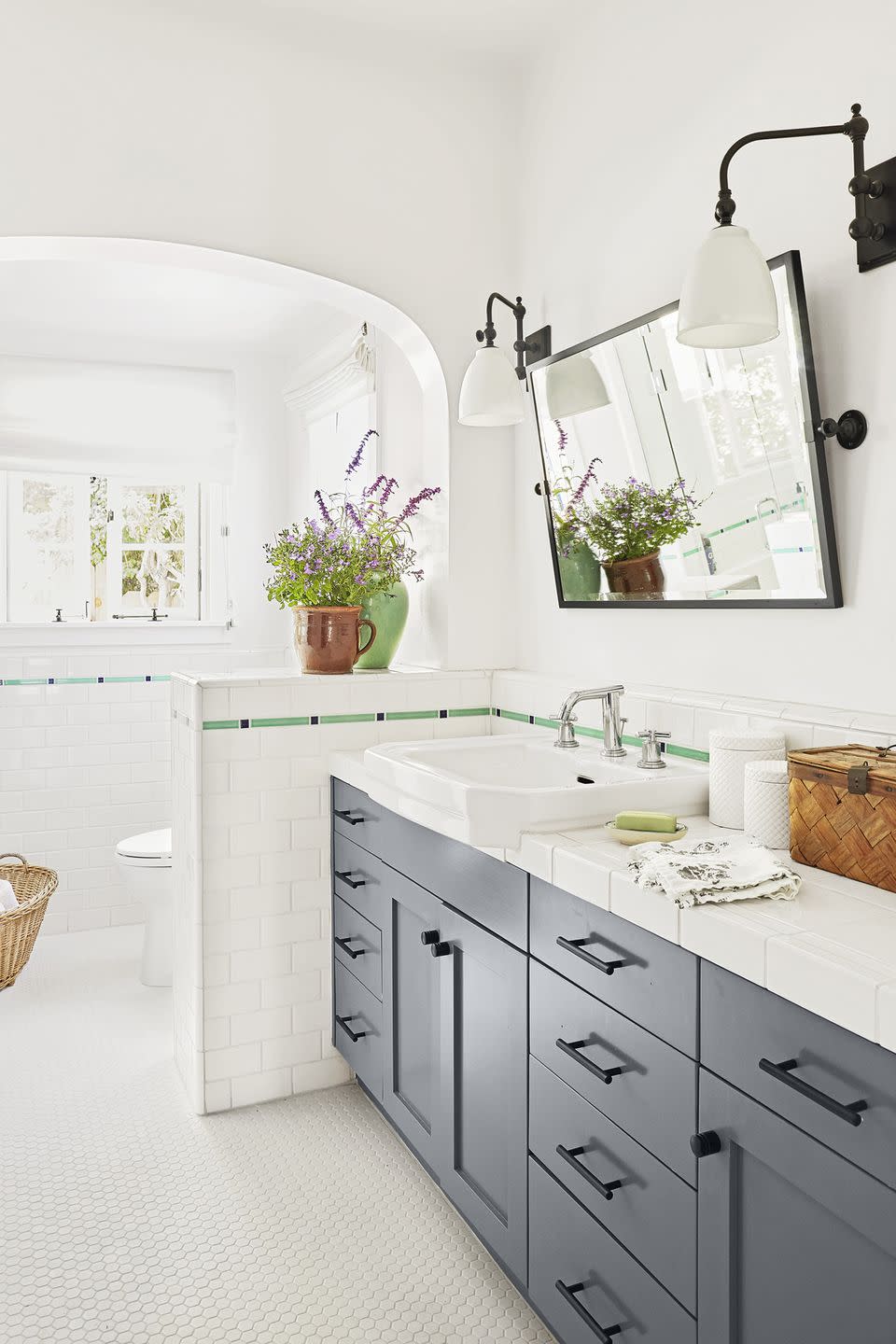 bathroom with white tile and slim green border