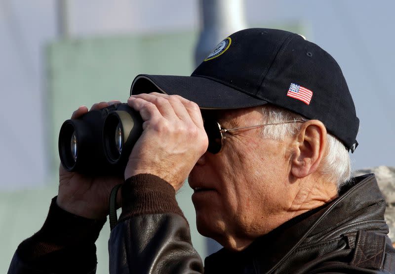 FILE PHOTO: U.S. Vice President Joe Biden looks through binoculars to see North Korea from Observation Post Ouellette during a tour of the DMZ, the military border separating the two Koreas, in Panmunjom