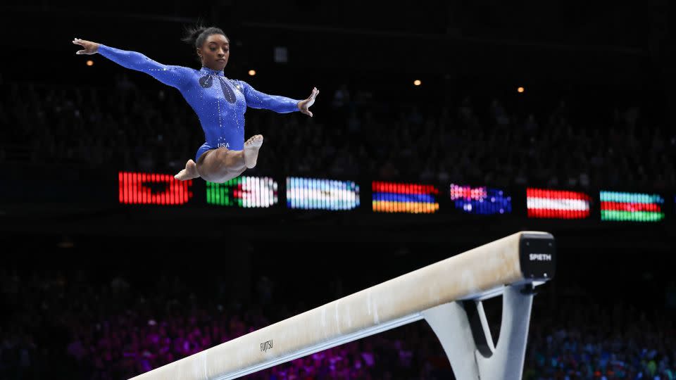 Biles competes on the beam during the women's all-round final. - Geert vanden Wijngaert/AP