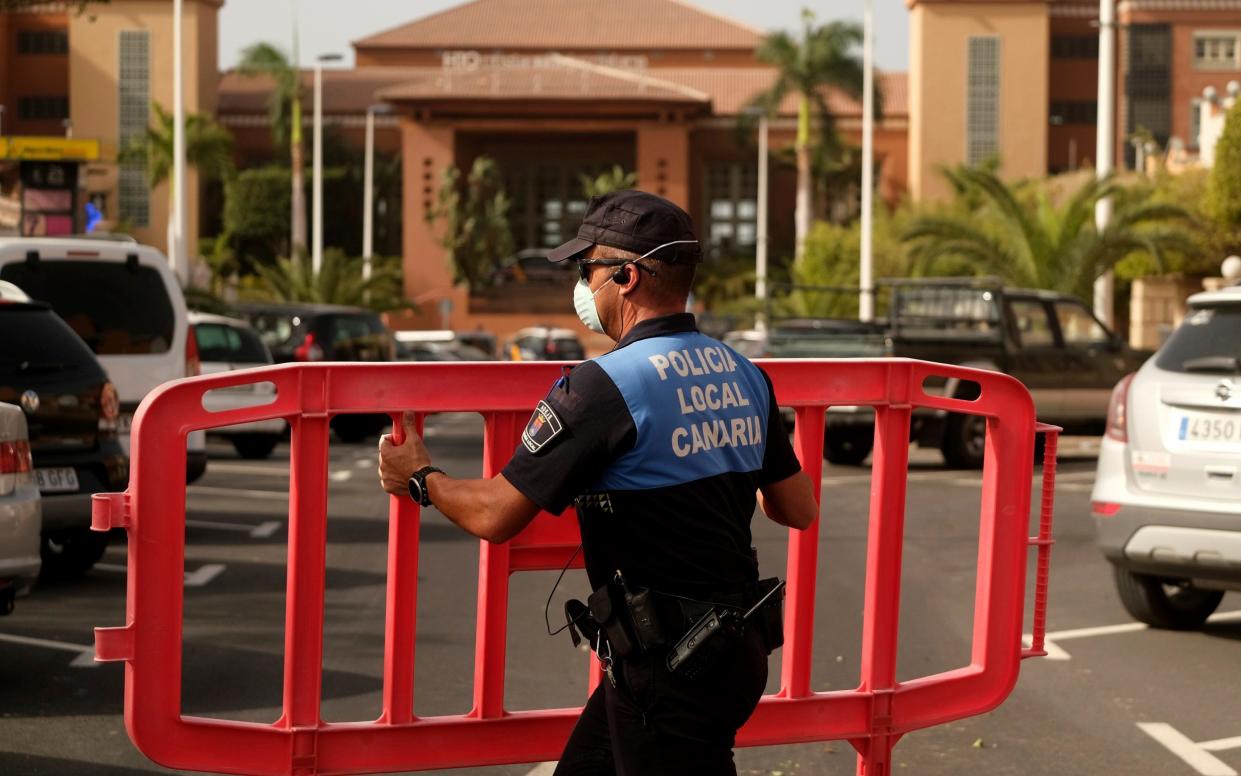 Sealed off: Police barriers block access to the H10 Costa Adeje Palace hotel in Tenerife - AP Photo