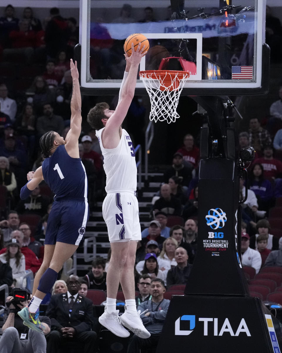 Northwestern's Matthew Nicholson dunks as Penn State's Seth Lundy defends during the first half of an NCAA college basketball game at the Big Ten men's tournament, Friday, March 10, 2023, in Chicago. (AP Photo/Charles Rex Arbogast)