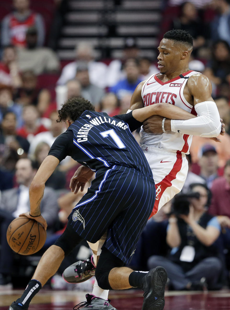 Houston Rockets guard Russell Westbrook, right, holds Orlando Magic guard Michael Carter-Williams (7) during the first half of an NBA basketball game Sunday, March 8, 2020, in Houston. (AP Photo/Michael Wyke)