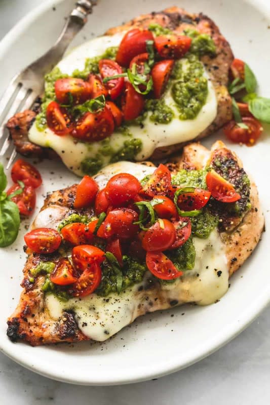 Le Creme de La Crumb<p>This super easy, grilled chicken margherita is incredibly tasty and is ready in less than 30 minutes!</p><p><strong>Get the recipe: <a href="https://www.lecremedelacrumb.com/grilled-chicken-margherita/" rel="sponsored" target="_blank" data-ylk="slk:Grilled Chicken Margherita;elm:context_link;itc:0;sec:content-canvas" class="link "><em>Grilled Chicken Margherita</em></a></strong></p>