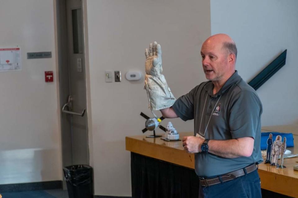 Brian Ewenson holds a space glove during a presentation at Lower Canada College in Montreal, Quebec.