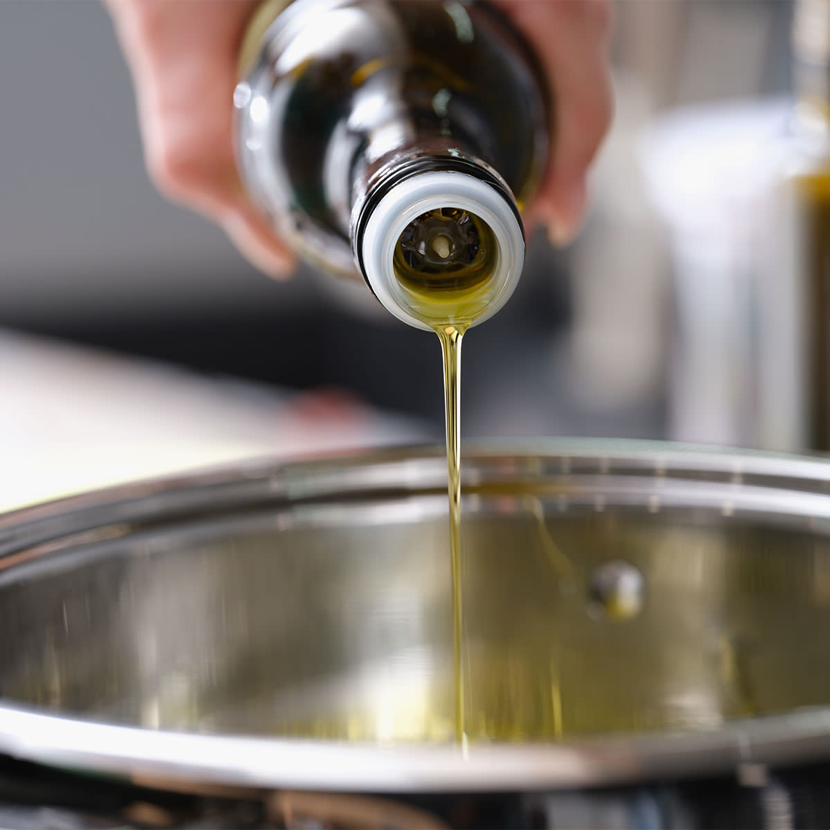 pouring olive oil into pot