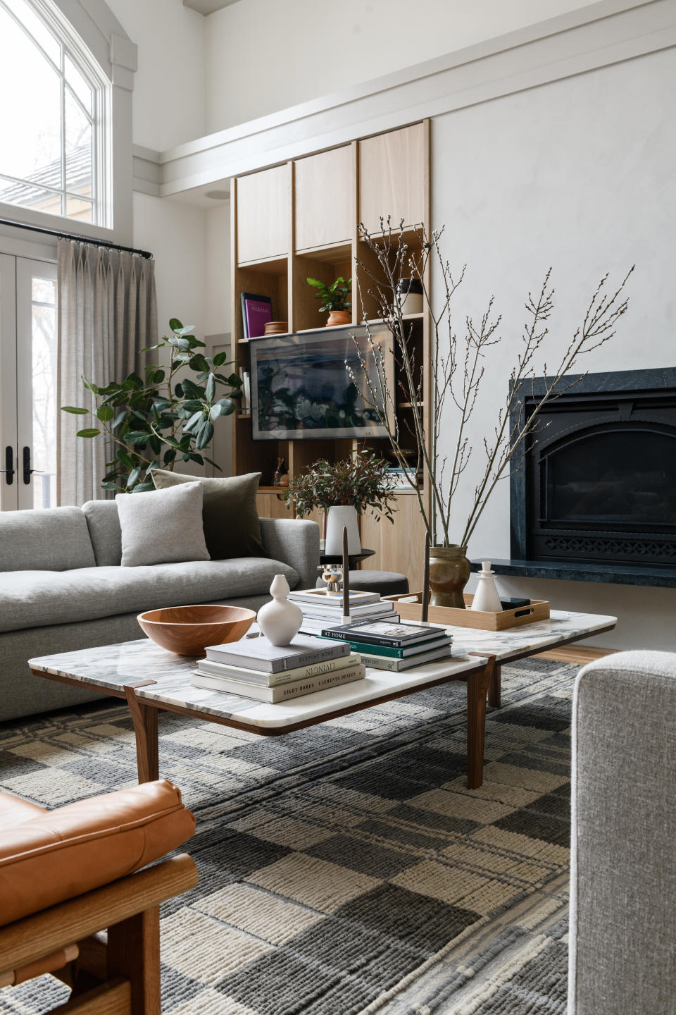 a coffee table covered with stacks of decor