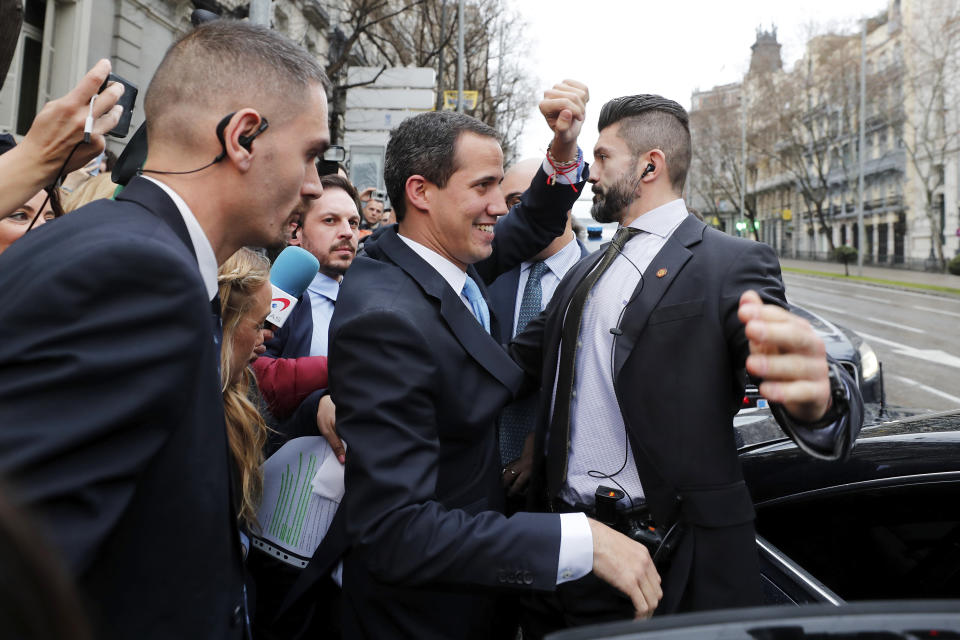 The leader of Venezuela's political opposition Juan Guaido waves during a visit to Madrid, Spain, Saturday, Jan. 25, 2020. Juan Guaido, the man who one year ago launched a bid to oust Venezuelan President Nicolas Maduro, arrived Saturday in Spain, where a thriving community of Venezuelans and a storm among Spanish political parties awaited him. (AP Photo/Paul White)