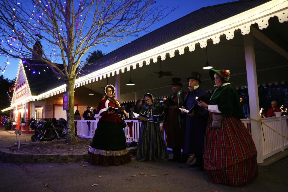 Carolers entertain visitors during Edaville's Christmas Festival of Lights on Thursday, Nov. 10, 2022 at Edaville Family Theme Park in Carver.