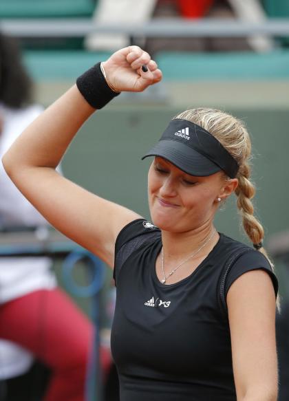 France's Kristina Mladenovic clenches her fist after defeating Canada&#39;s Eugenie Bouchard during their first round match of the French Open tennis tournament at the Roland Garros stadium, Tuesday, May 26, 2015 in Paris. Mladenovic won 6-4, 6-4. (AP Photo/Francois Mori)