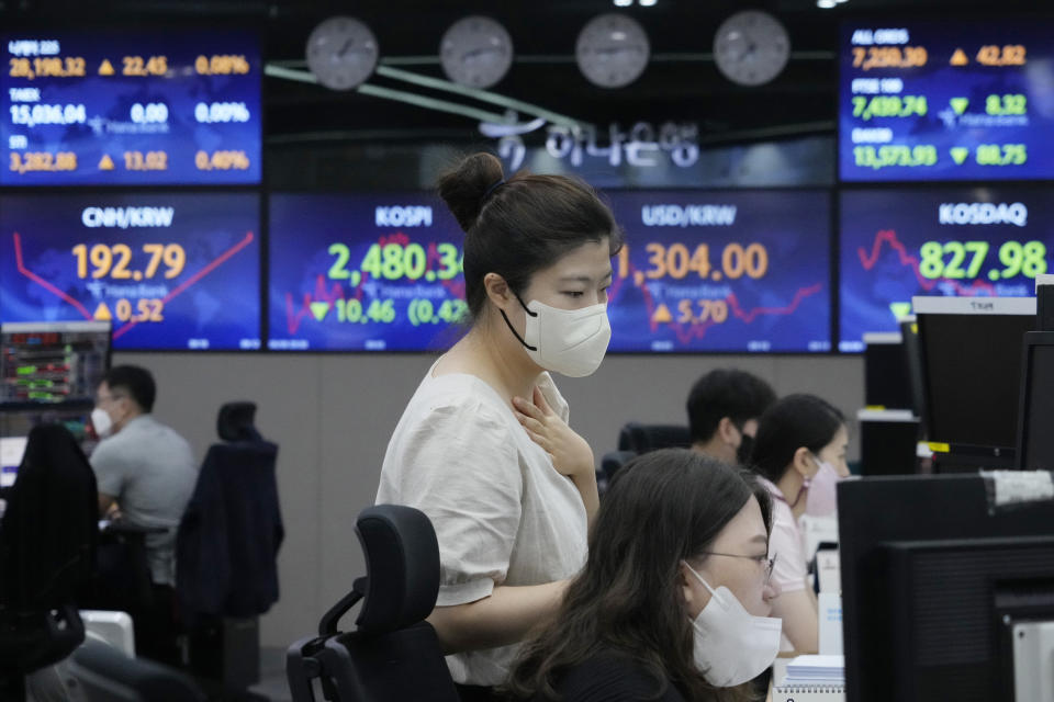 Currency traders watch monitors at the foreign exchange dealing room of the KEB Hana Bank headquarters in Seoul, South Korea, Monday, Aug. 8, 2022. Asian stocks were mixed Monday after strong U.S. jobs data cleared the way for more interest rate hikes and Chinese exports rose by double digits. (AP Photo/Ahn Young-joon)