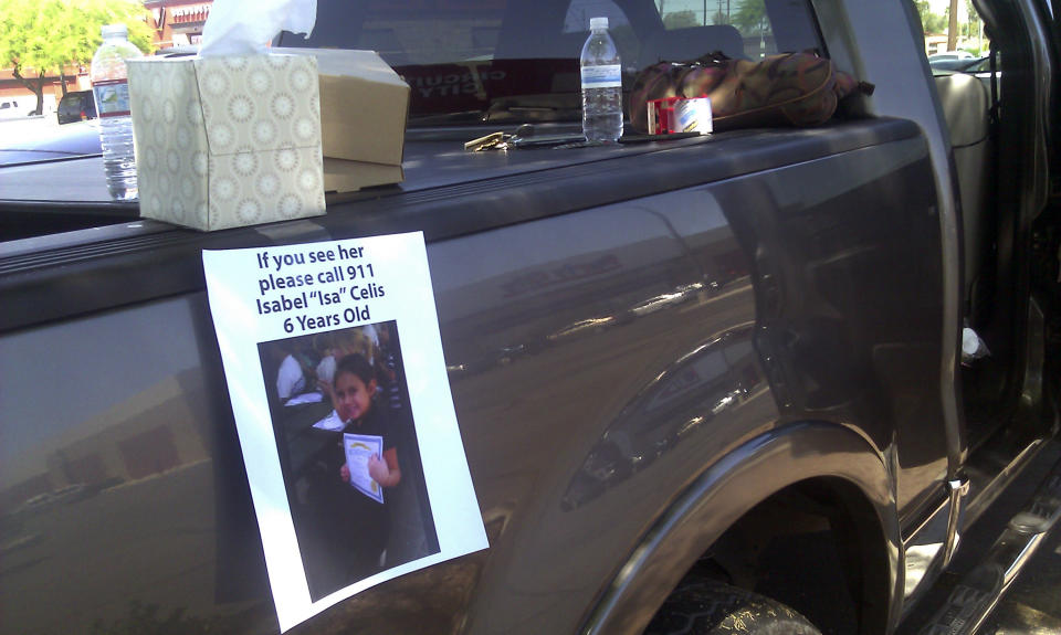 FILE - In this April 22, 2012, file photo, a flyer for missing 6-year-old Isabel Celis is placed on a volunteer's car in Tucson, Ariz. Tucson police Chief Chris Magnus says remains found in a remote area in Pima County about a month ago are those of Celis, who went missing from her family home nearly five years ago. Magnus said Friday, March 31, 2017, that an independent lab identified the remains as those of Celis. He said an investigation is ongoing but would not say whether there were any new suspects. (AP Photo/Terry Tang, File)