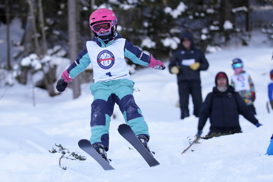 Five-year-old Aerin Sheil, of Lakeville, Conn., catches air off a 10-meter jump during the Eastern Ski Jumping Meet, Sunday, Jan. 21, 2024, in Milan, N.H. Aerin, the event's youngest competitor, is intent on following her older siblings in pursuit of long distance flight. (AP Photo/Robert F. Bukaty)