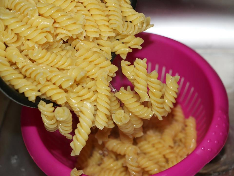 straining pasta sink