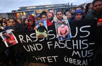 People attend a vigil for the victims of a shooting in Hanau