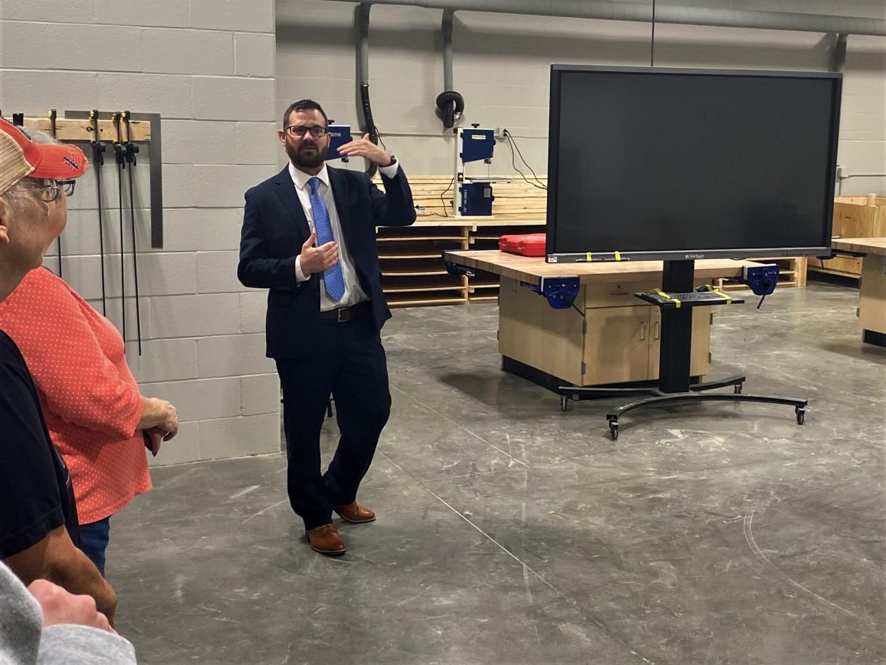 Justin Griffith, principal at Southern Boone Middle School, on Thursday leads a tour group through the new middle school addition stopping here at the new wood shop.